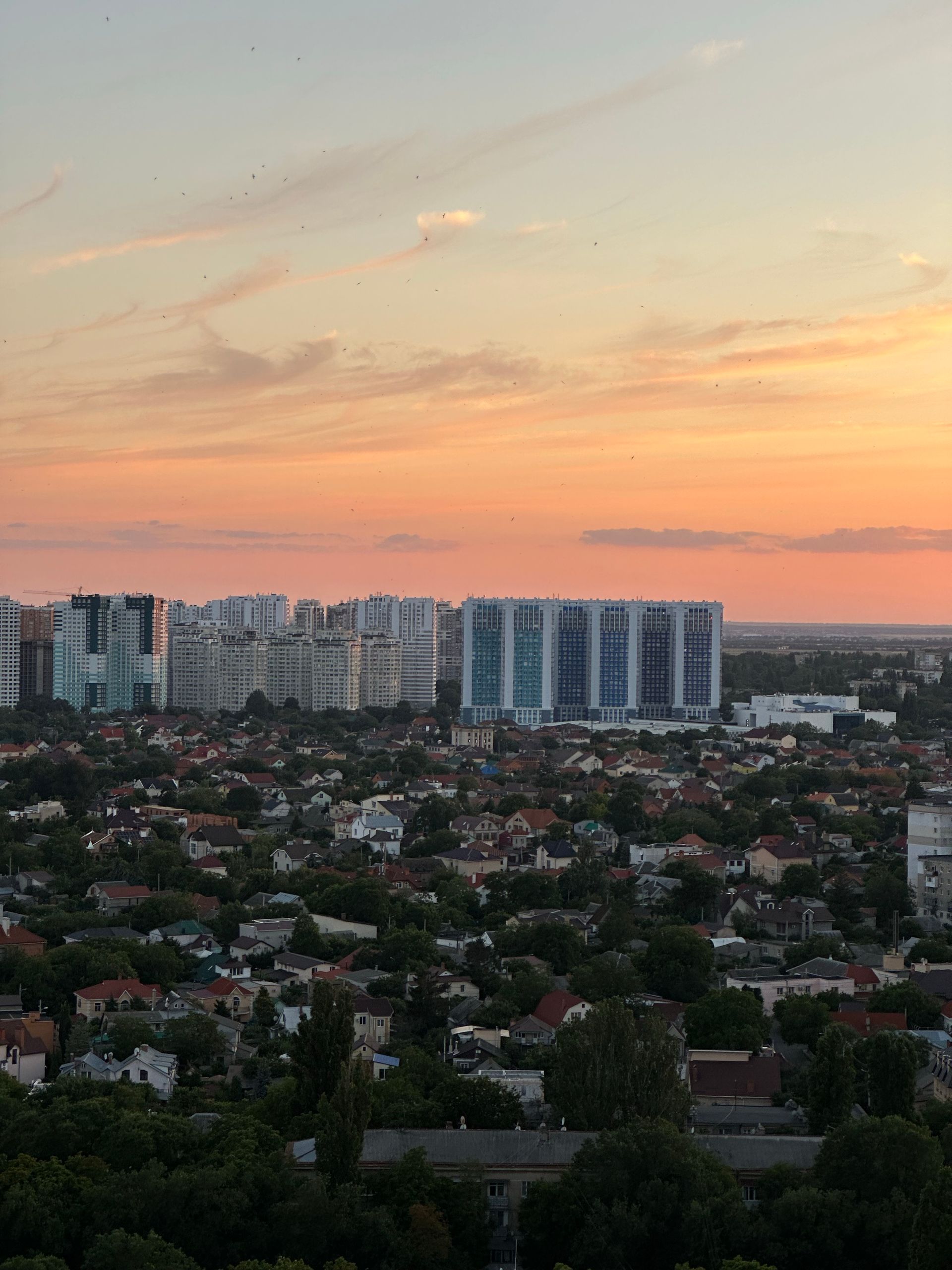 A beautiful sunset panorama showcasing Odessa's urban skyline with modern residential buildings.
