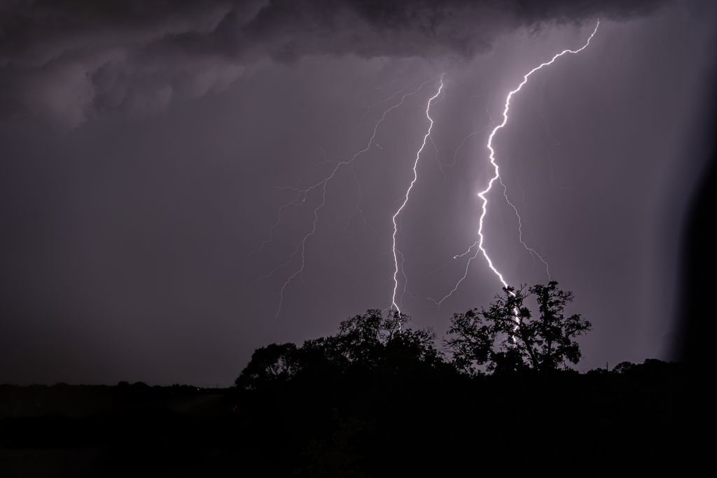 A stunning capture of multiple lightning bolts illuminating the night sky over Cedar Park, Texas.